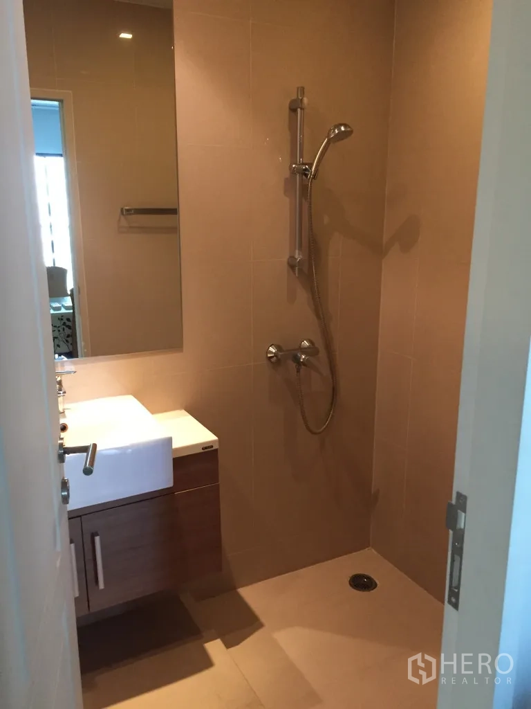 Condominium for rent in Bangkok - Second bathroom with walk-in shower and vanity cabinet.
