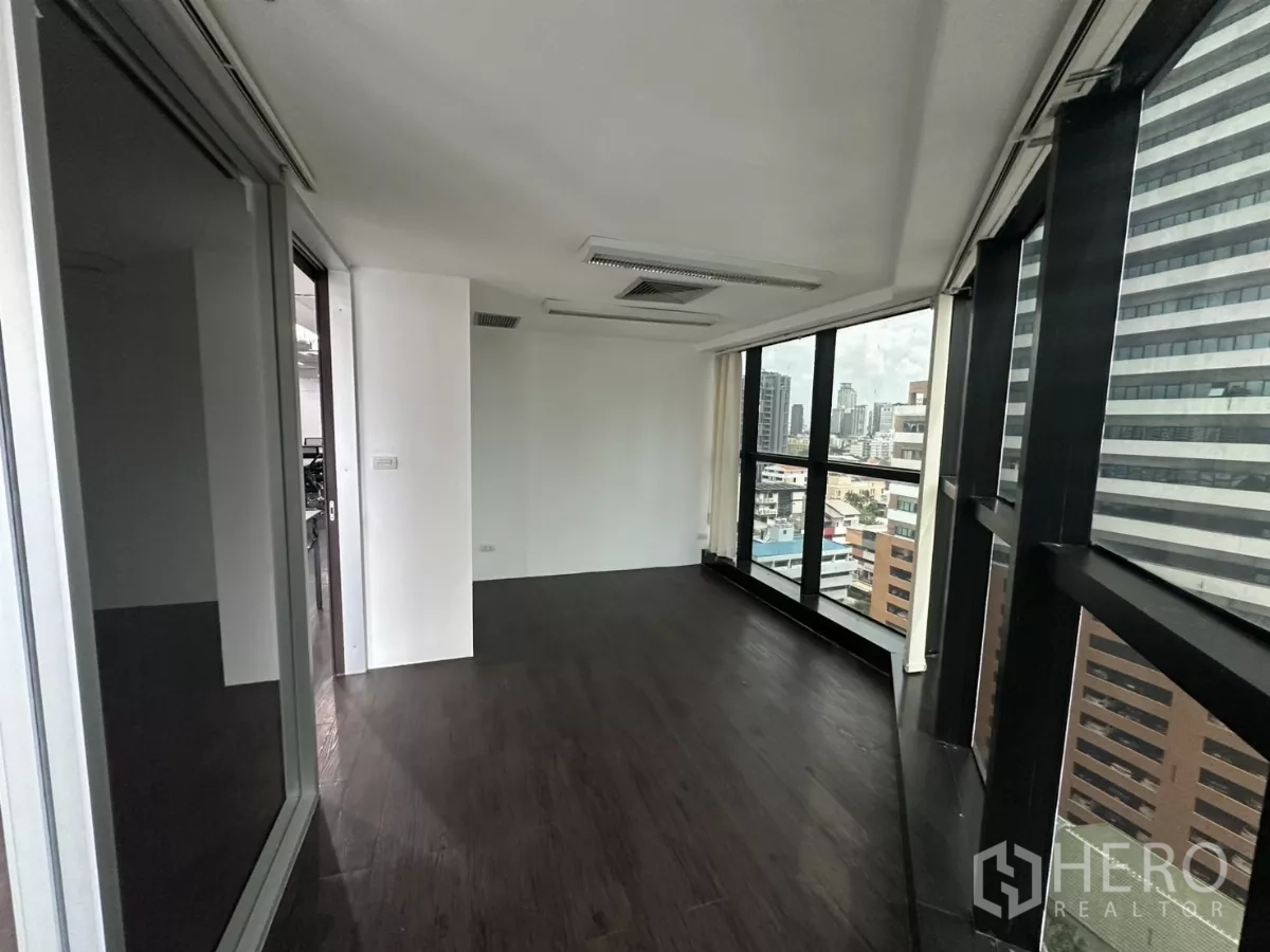 Office Space for rent in Watthana, Bangkok - Narrow corner room with full-height windows and urban views toward Sukhumvit.