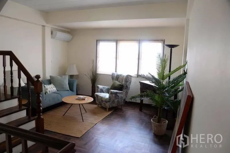 带办公室的家 出租在Min Buri, Bangkok - 楼上休闲区，沙发与单椅，木质楼梯与人字拼地板