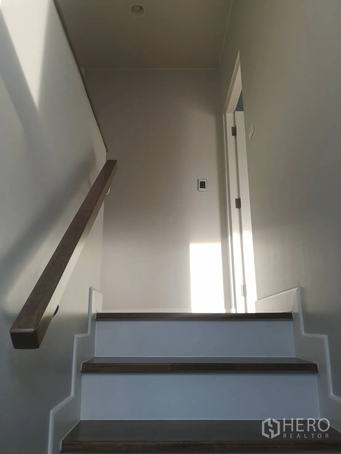 Detached House for sale in Lam Luk Ka, Pathum Thani - Upper staircase landing with natural light and wooden treads.