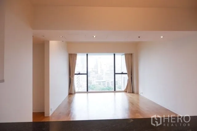 Condominium for sale in Sathon, Bangkok - Spacious living room with wide picture window and panoramic city outlook.