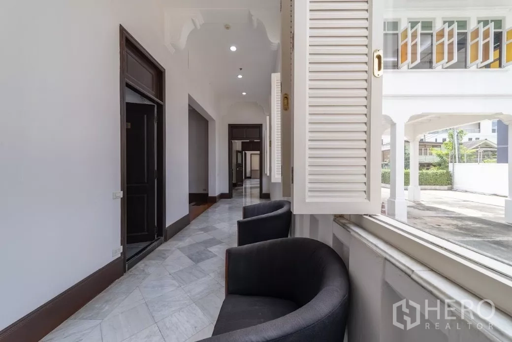 Retail Space for rent in Bang Rak, Bangkok - Shaded veranda corridor with open shutters and lounge chairs facing driveway