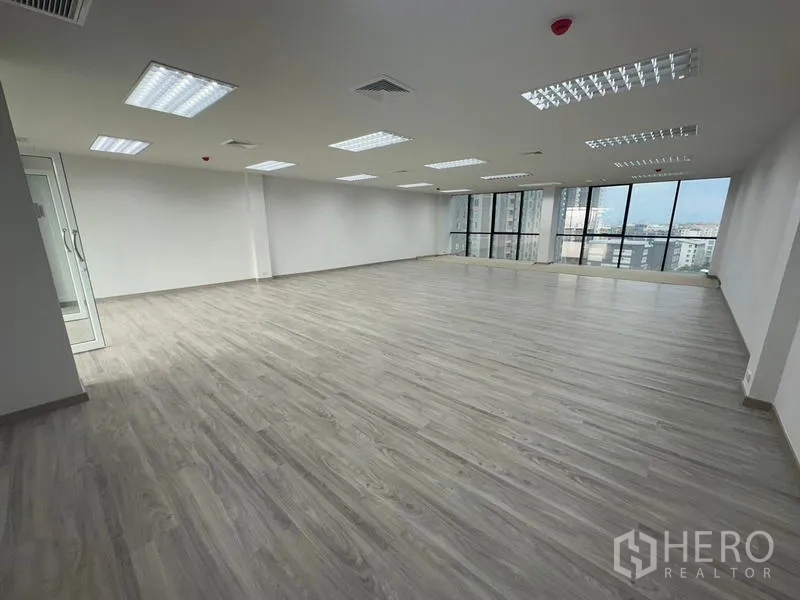 Office Space for rent - Corner office space with glass entry door, wood-look flooring and city views near MRT Huai Khwang.
