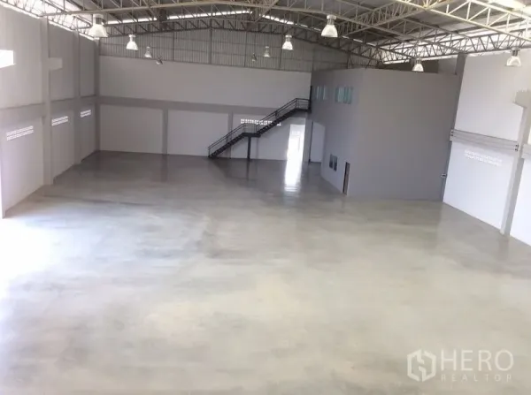 โรงงาน ขายในBang Sao Thong, Samut Prakan - โถงคลังสินค้ากว้าง พื้นคอนกรีตขัดมัน โครงหลังคาเหล็ก และบันไดขึ้นสำนักงาน.