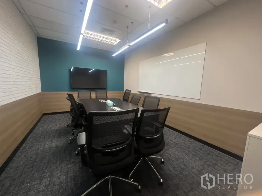 สำนักงาน ให้เช่าในHuai Khwang, Bangkok - ห้องประชุมโต๊ะยาว เก้าอี้ตาข่าย ทีวีติดผนัง กระดานไวท์บอร์ด และไฟแบบเส้นบนเพดาน