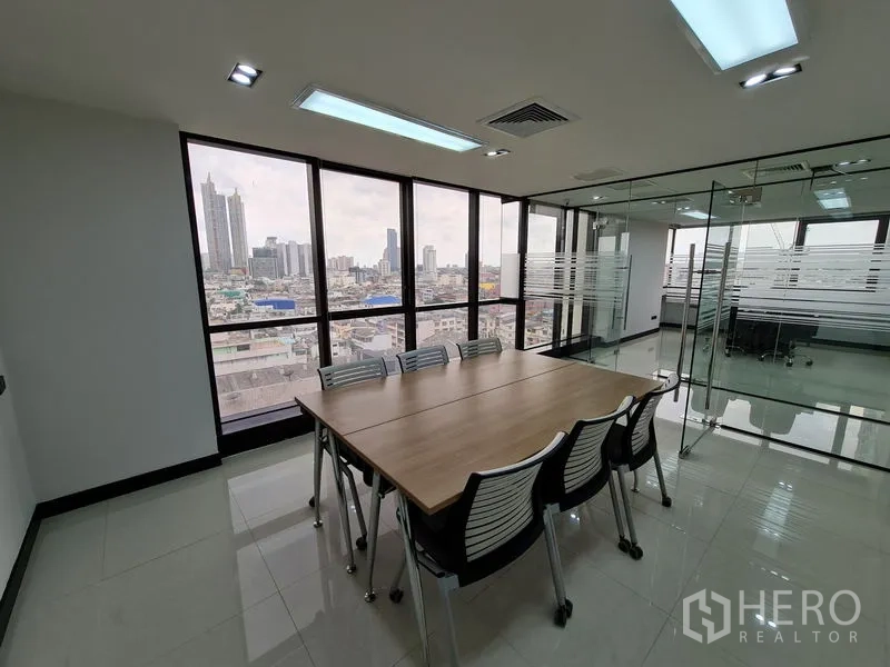 Office Space for rent in Bang Rak, Bangkok - Meeting room facing large windows with expansive city skyline views.