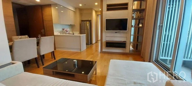 คอนโด ให้เช่าในRatchathewi, Bangkok - ห้องนั่งเล่นแบบโอเพ่นสเปซ พร้อมโซฟา ทีวีติดผนัง และครัวสมัยใหม่
