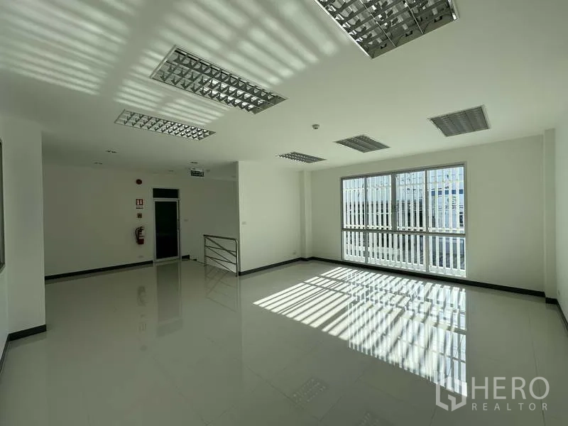 Factory for rent in Bang Sao Thong, Samut Prakan - Second-floor office room with large windows and natural light.