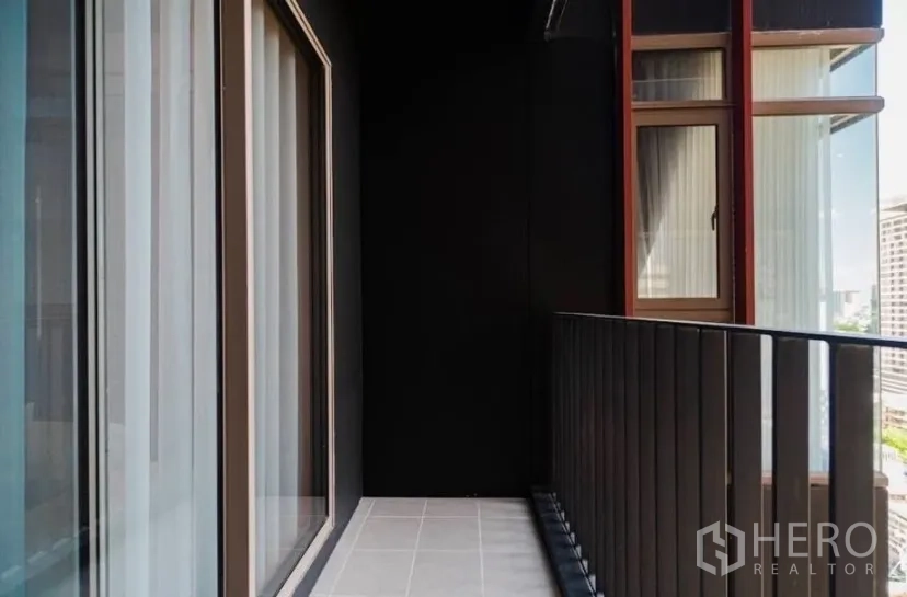 Condominium for rent in Watthana, Bangkok - Private balcony with sliding glass doors and metal railing.