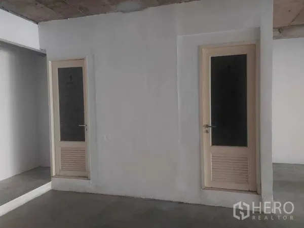 Retail Space for rent in Pathum Wan, Bangkok - Interior partition with two doors inside an unfinished retail space, suitable for back-of-house or restroom area.