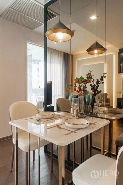 Condominium for rent in Khlong Toei, Bangkok - Bedroom outlook to teal sliding doors opening to a vanity and dressing area.
