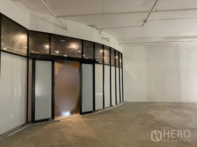 Retail Space for rent - Wide shopfront with sliding glass doors and frosted panels facing a spacious interior.