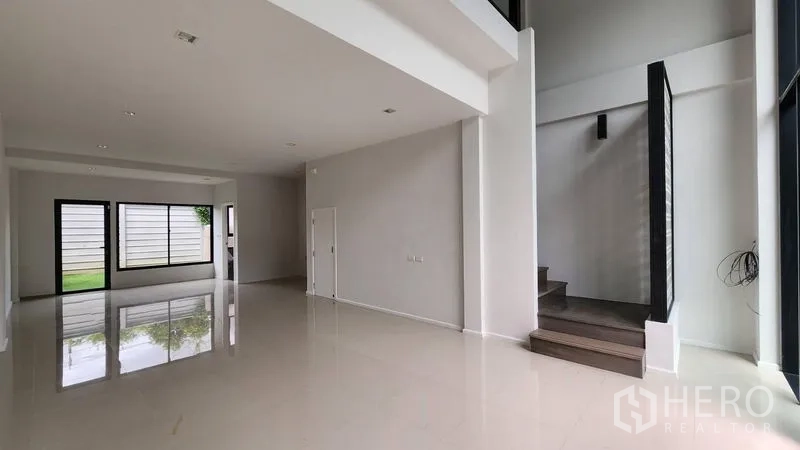 Home Office for rent - Bright lobby with glossy tile floors and a contemporary staircase.