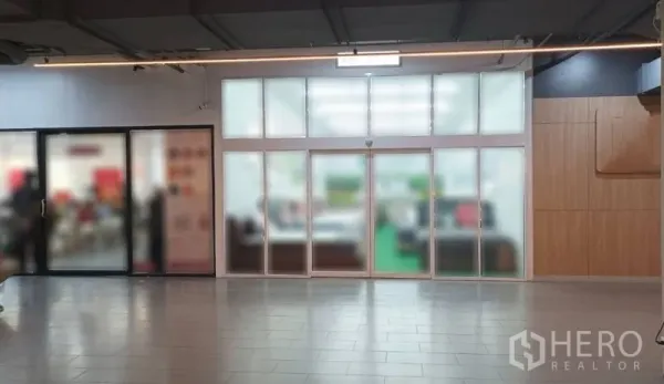 Retail Space for rent in Watthana, Bangkok - Indoor mall frontage featuring large frosted-glass sliding doors and a wide tiled walkway.