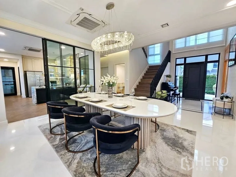 Detached House for rent or sale in Saphan Sung, Bangkok - Bright dining room with a crystal chandelier, glass partition and staircase in a luxury Bangkok detached house.