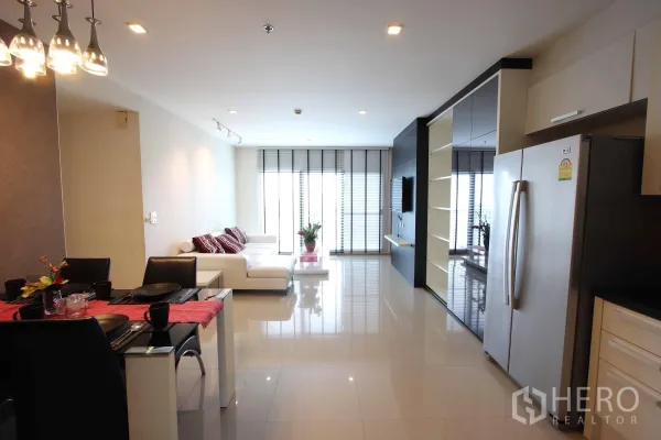 Condominium for rent in Khlong Toei, Bangkok - Open-plan living, dining and kitchenette in a Khlong Toei Bangkok condo with glossy floors, stainless fridge and floor-to-ceiling windows.