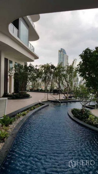 Condominium for rent in Bang Kho Laem, Bangkok - Curved water feature and landscaped garden beside a modern condominium.