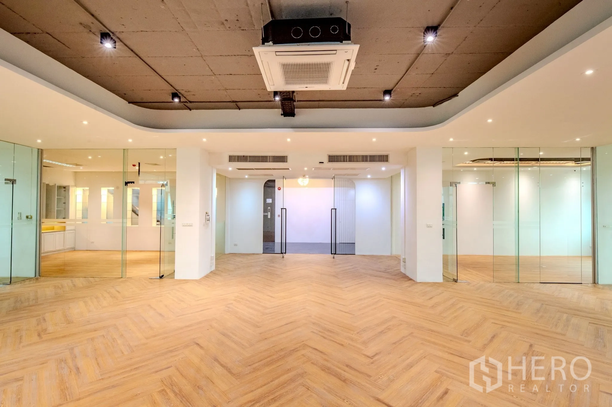 Office Space for rent in Wang Thonglang, Bangkok - Open office floor with glass rooms, herringbone wood flooring and cassette air-conditioning.