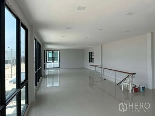 Factory for rent or sale in Bang Bo, Samut Prakan - Open-plan mezzanine office corridor with railing and glossy tiled floors inside the factory.