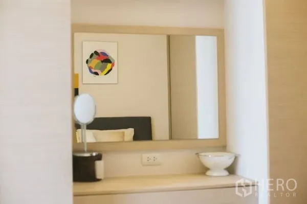 公寓 出售在Watthana, Bangkok - 梳妆镜映出温馨卧室与色彩鲜明的墙面艺术画。