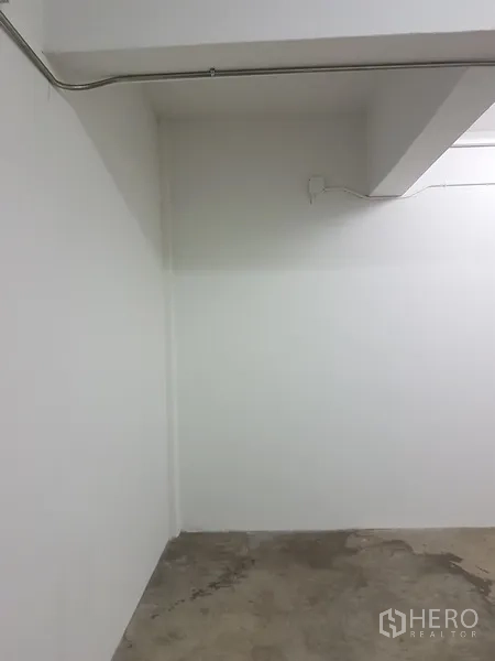 Home Office for sale in Khlong Toei, Bangkok - Small white utility space with concrete flooring.