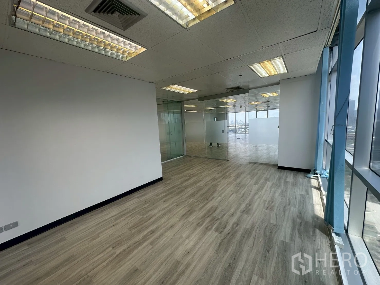 Office Space for rent - Small office section beside glass partitions with wraparound window line.