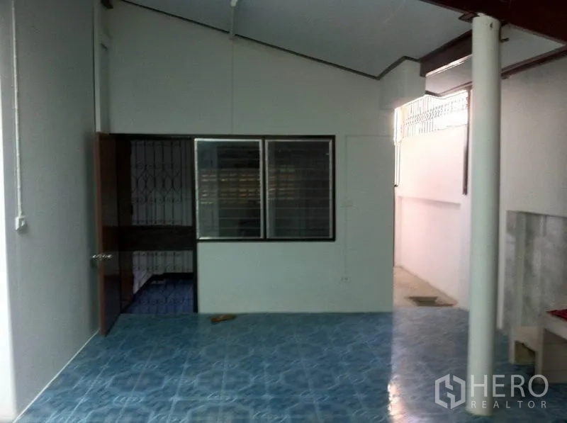 Warehouse for rent in Lam Luk Ka, Pathum Thani - Covered utility area with blue tile flooring, white walls and sliding windows.