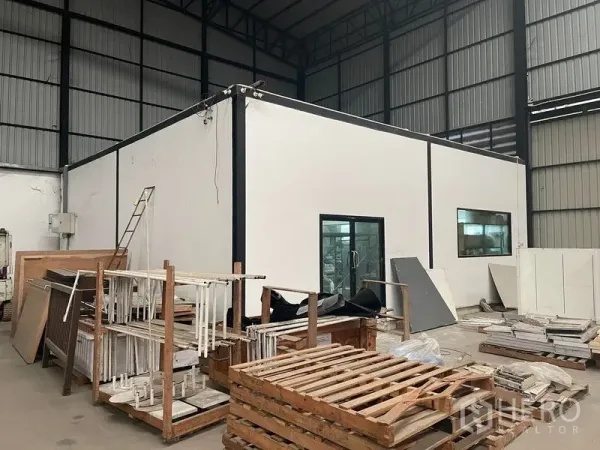 Warehouse for rent in Lat Krabang, Bangkok - Internal glass-front office set within a large warehouse storage hall.