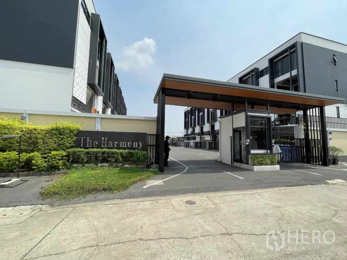 Home Office for rent in Khan Na Yao, Bangkok - Gated entrance of The Harmony estate with security booth and project sign.