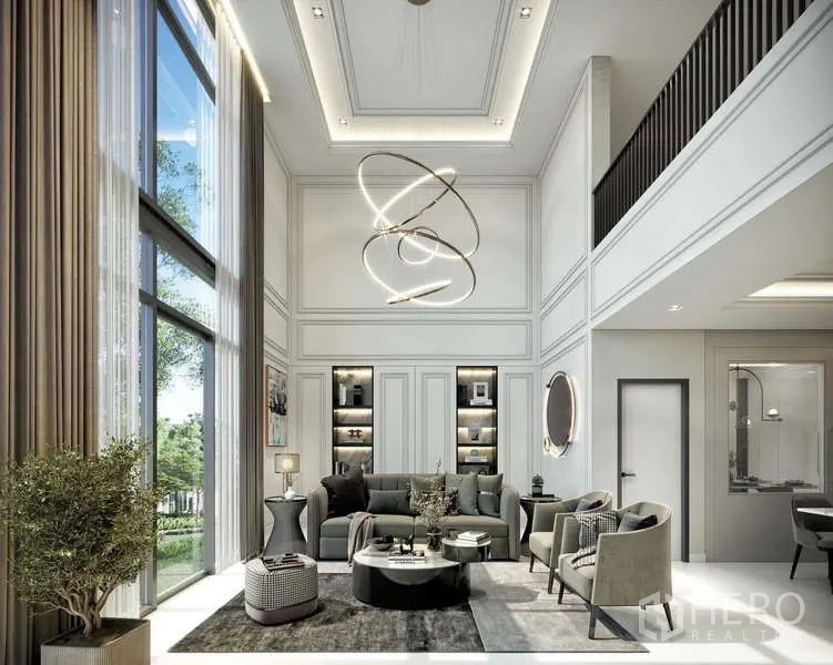 Townhouse for sale - Double-height living room with floor-to-ceiling windows, sculptural chandelier, built-in shelves and plush seating.