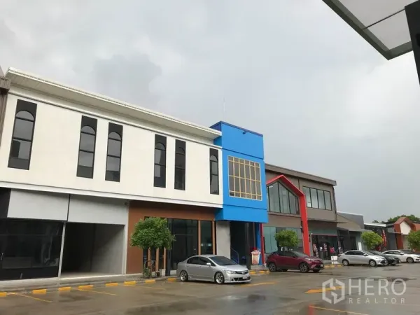 Retail Space for rent in Bang Na, Bangkok - Modern low-rise retail plaza exterior in Bang Na with colorful facades and on-site parking.