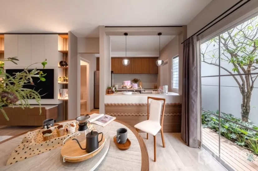 Townhouse for rent in Bang Phli, Samut Prakan - Modern kitchen with pendant lights facing a small garden and sliding glass door.