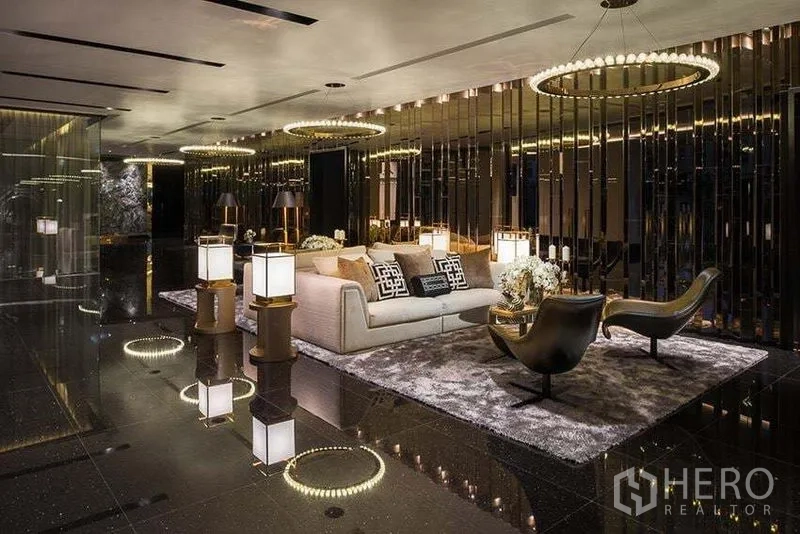 Condominium for rent in Khlong San, Bangkok - Luxurious lobby with circular chandeliers, mirrored walls, and plush seating areas.