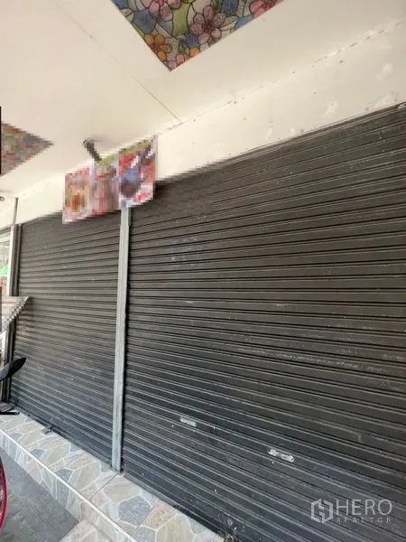 Retail Space for rent in Watthana, Bangkok - Street-level retail frontage with black roller shutter and tiled step in the Sukhumvit area.