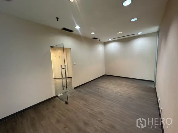 Office Space for rent in Bang Rak, Bangkok - Glass-door meeting room with recessed lighting and vinyl wood flooring.