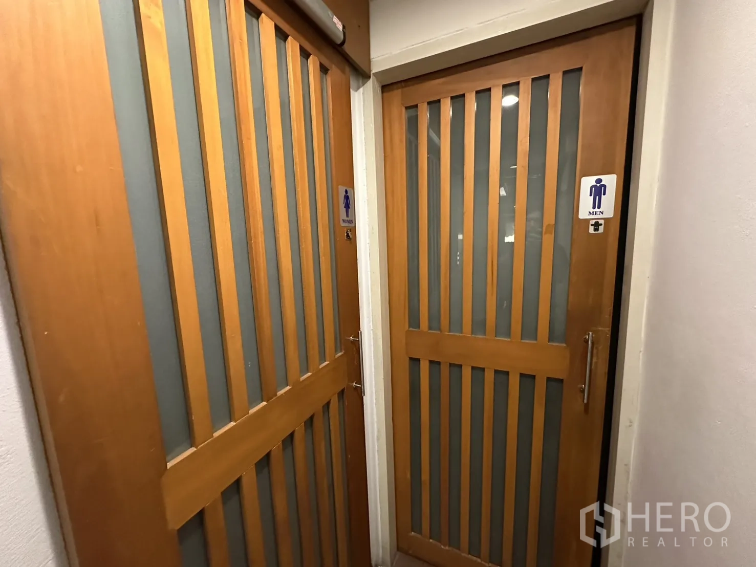 Retail Space for rent in Watthana, Bangkok - Separate men’s and women’s restroom doors with wood slat design.