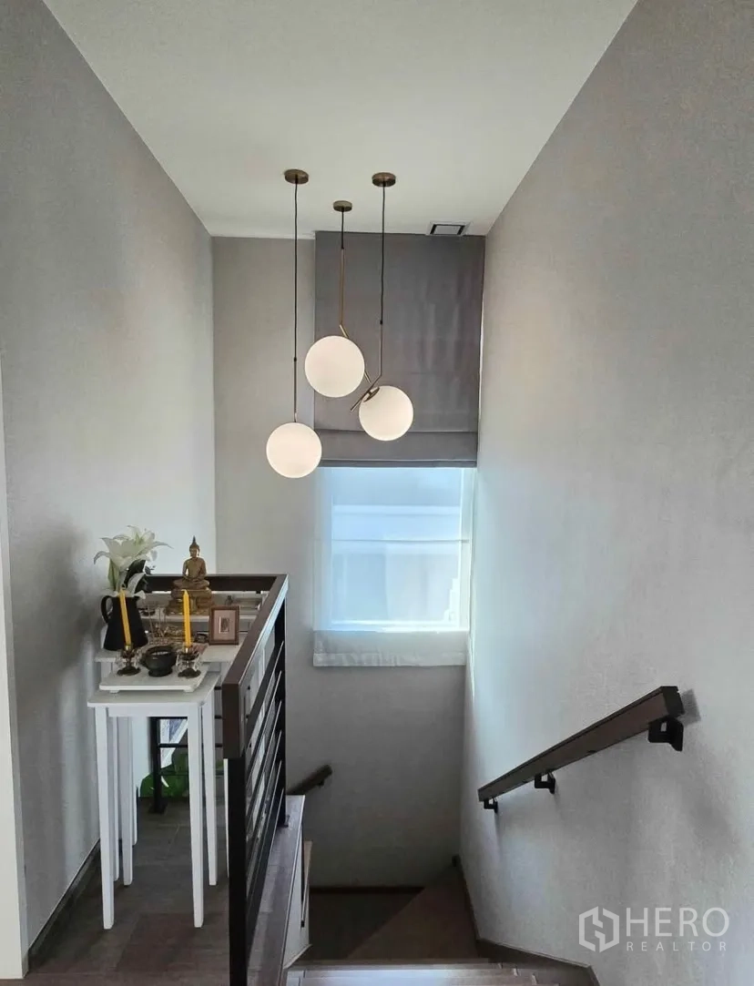 Detached House for rent in Bang Phli, Samut Prakan - Stairwell with modern pendant lights and small altar table