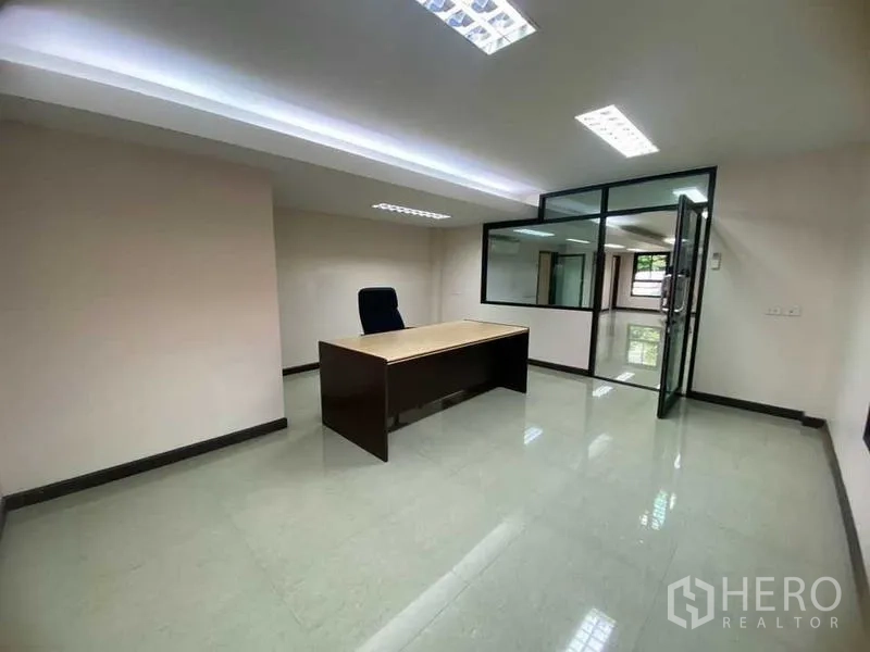 Home Office for rent in Don Mueang, Bangkok - Private glass-partitioned office with desk and chair.