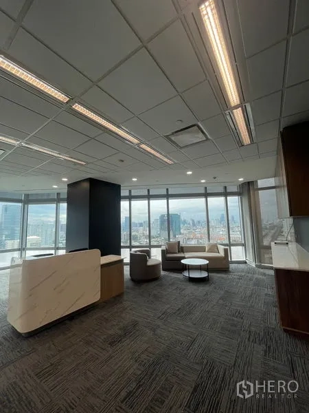Office Space for rent in Dusit, Bangkok - Modern reception and client lounge with marble counter, armchairs and wide city views.
