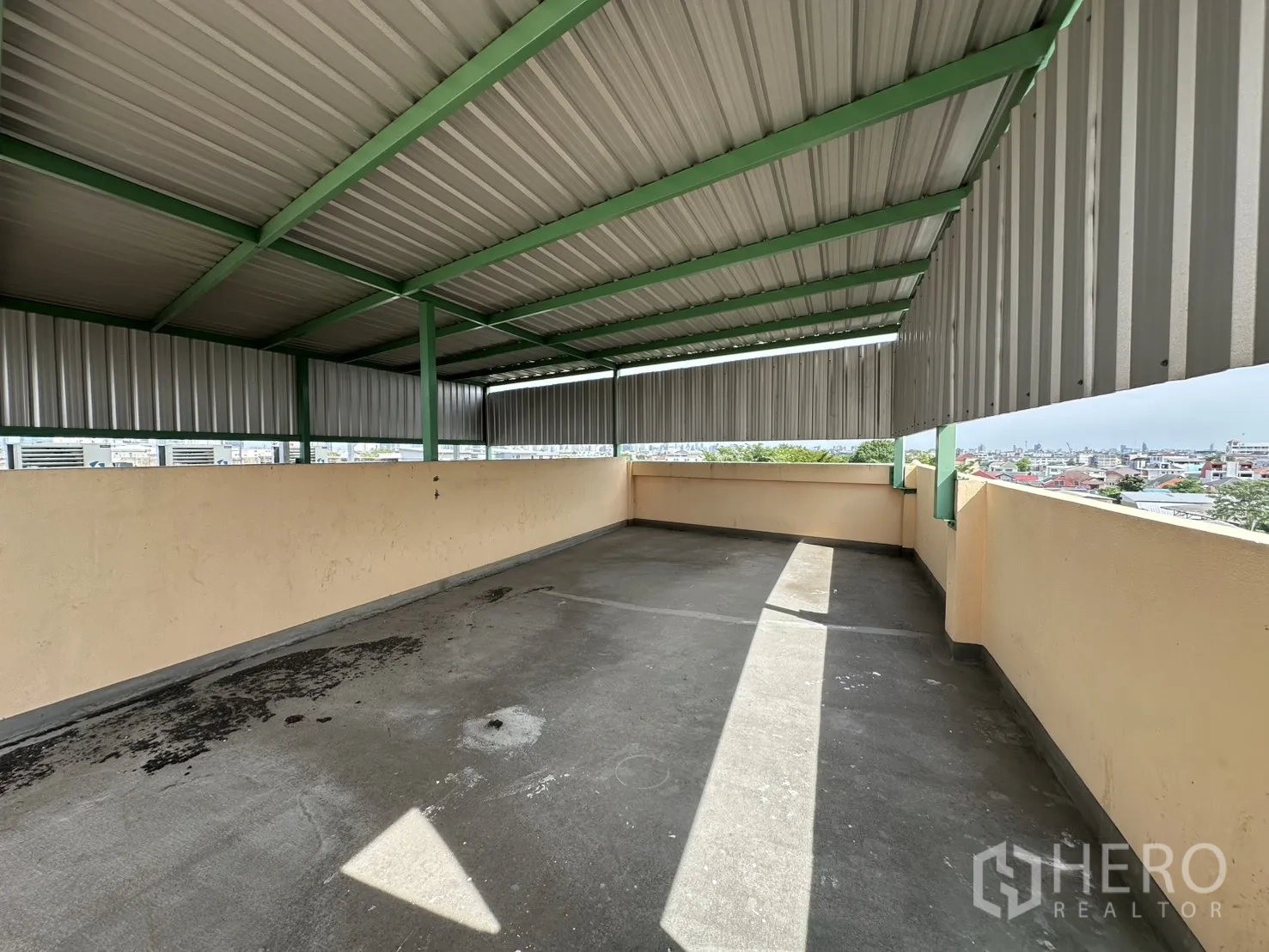 Shophouse for rent in Phra Khanong, Bangkok - Covered rooftop terrace with open city skyline views.