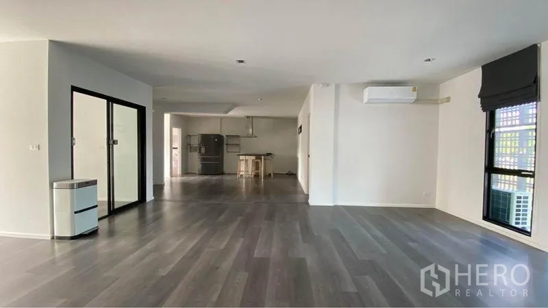 Retail Space for sale in Bang Na, Bangkok - Wide open area with air‑conditioning, a glass meeting room and pantry in the background.