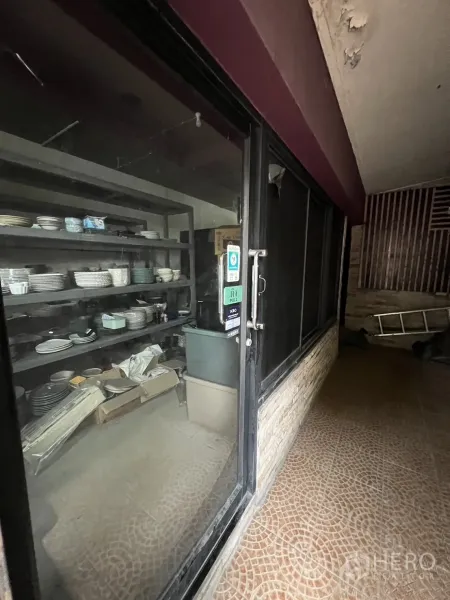 Retail Space for rent in Watthana, Bangkok - Interior glass door with shelving area inside the retail unit, ready for fit-out.