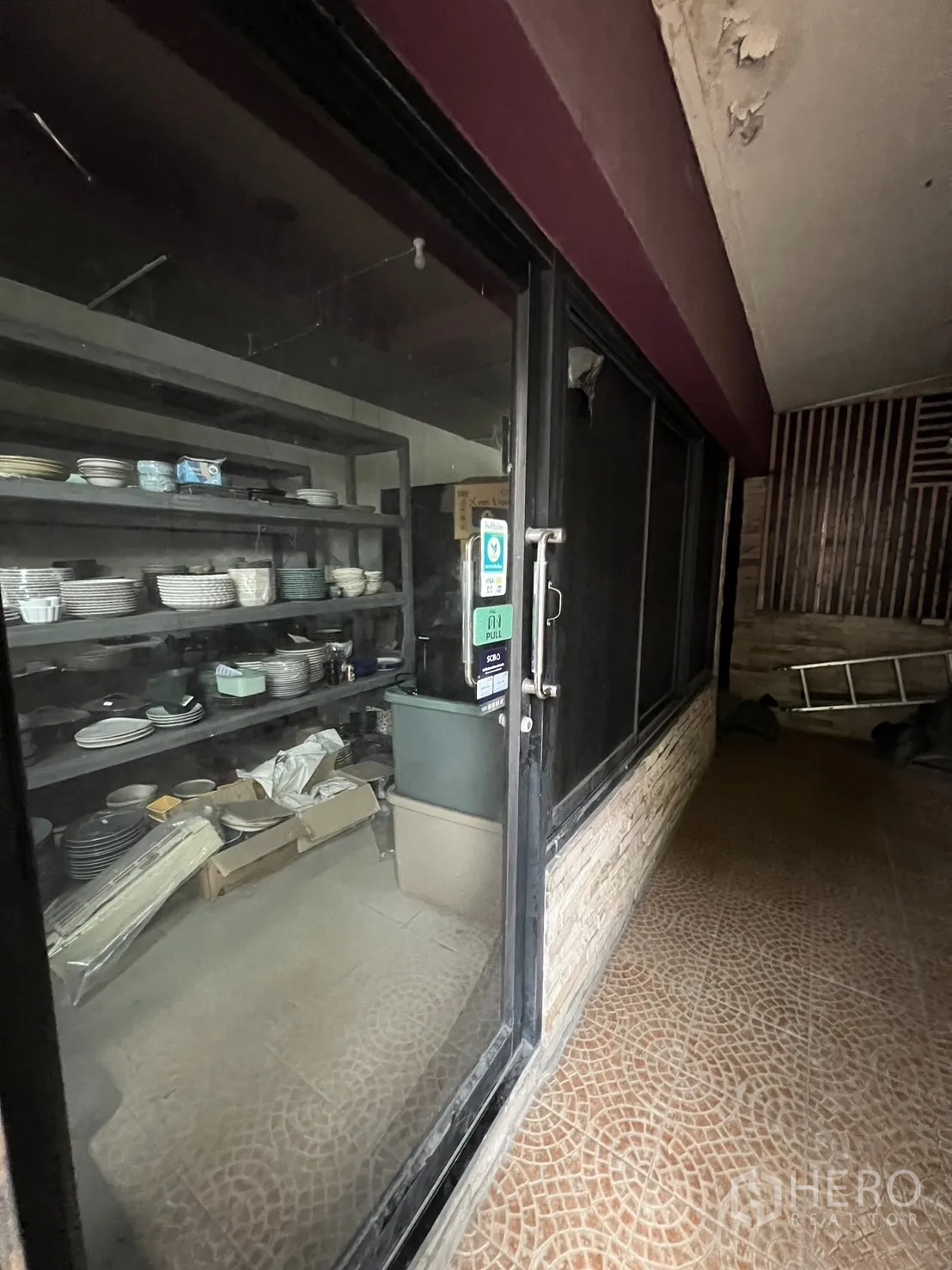 Retail Space for rent in Watthana, Bangkok - Interior glass door with shelving area inside the retail unit, ready for fit-out.