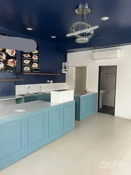 Retail Space for rent in Watthana, Bangkok - Another view of the fitted counter and sink area under a navy ceiling with recessed lighting.