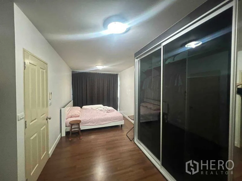 Townhouse for rent in Bueng Kum, Bangkok - Spacious master bedroom with large sliding wardrobe and bed.