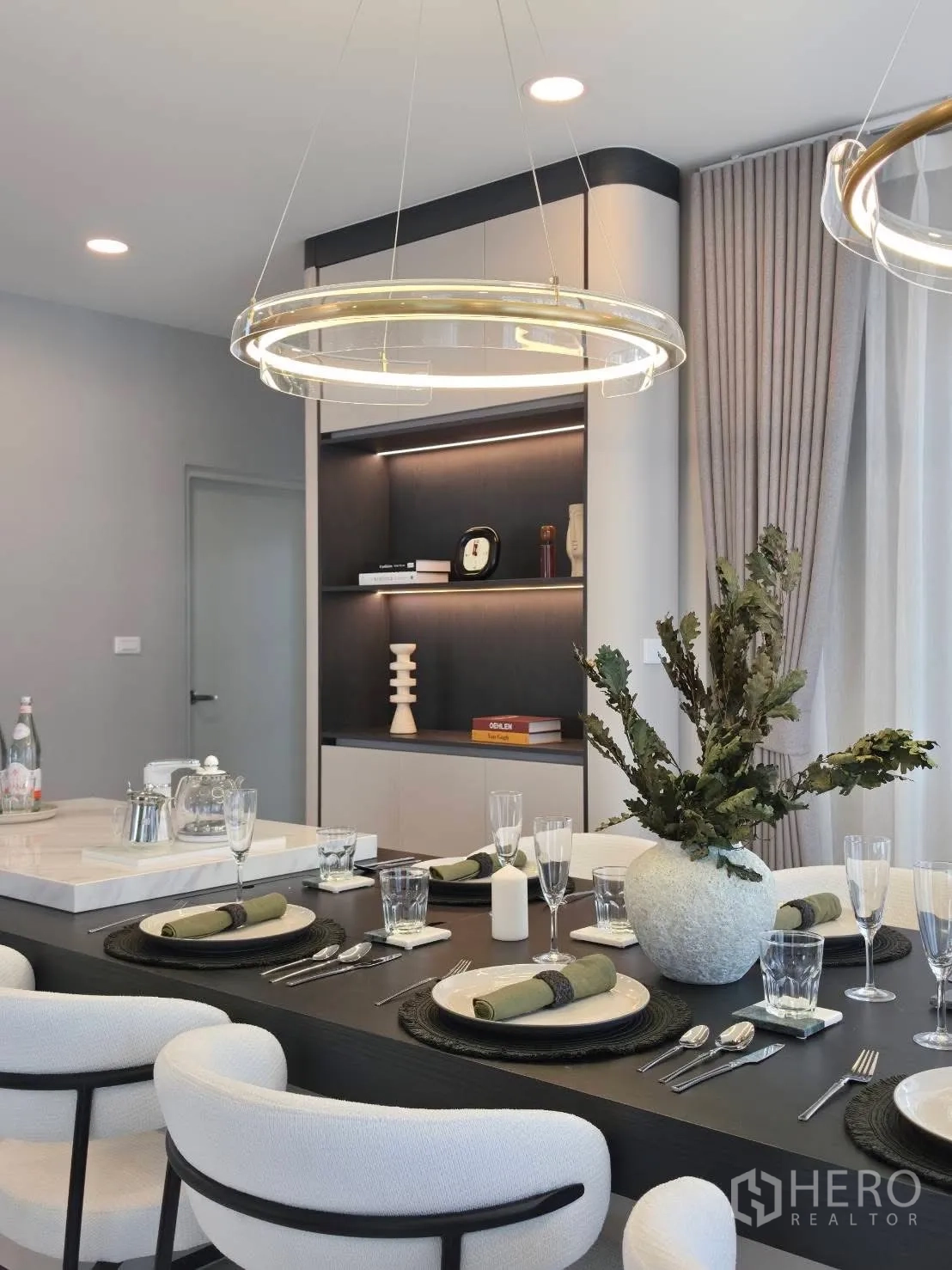 Detached House for rent in Bang Phli, Samut Prakan - Dining area set for six with ring chandeliers and built-in shelves.