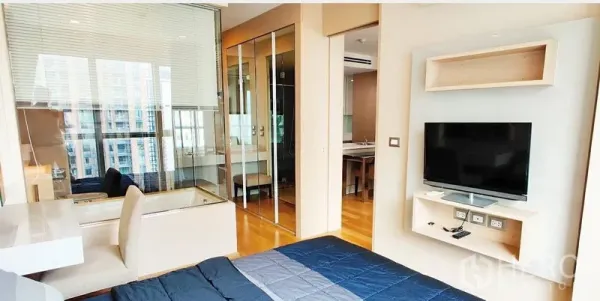 公寓 出租在Ratchathewi, Bangkok - 卧室带电视与书桌，玻璃墙浴室设计，木地板温暖舒适。