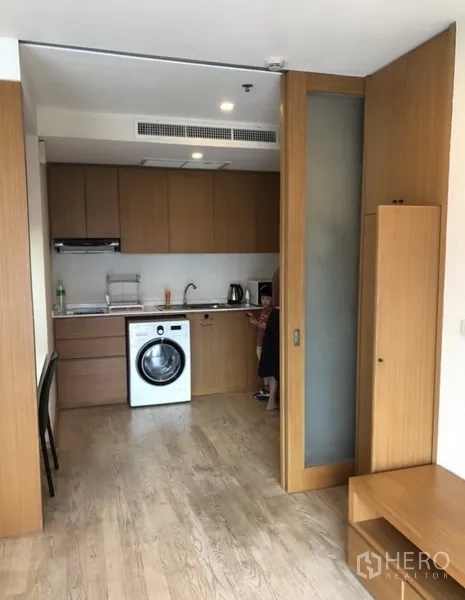 公寓 出租在Khlong Toei, Bangkok - 带玻璃移门的厨房，洗衣机和吊柜，紧凑实用