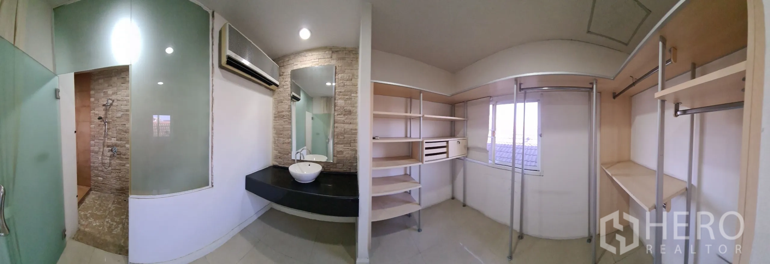 Detached House for sale in Chatuchak, Bangkok - Ensuite with glass shower, vanity and walk-in wardrobe shelving.
