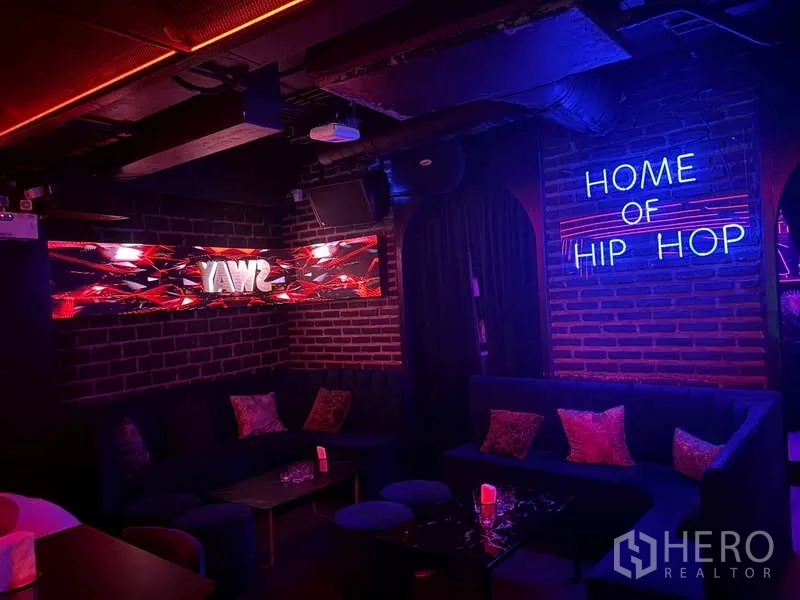 Retail Space for rent in Bangkok - Brick lounge corner with neon signage and banquette seating.